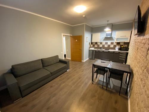 a living room with a couch and a table at ApartHotel Riga in Rīga