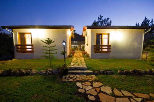 a house with a pathway leading to the front yard at BellaTroun Chalet in Kefar Bin-Nun