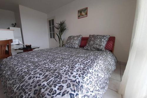 um quarto com uma cama com estampa de leopardo num quarto em 2 pièces avec Terrasse, Piscine, parking privatif em Besançon