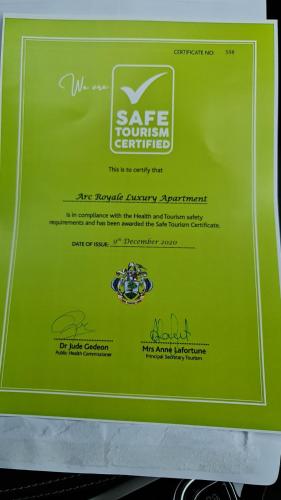 a green sign that says safe journey continued at Royale Suites by Arc Royal Luxury Apts in Anse Royale