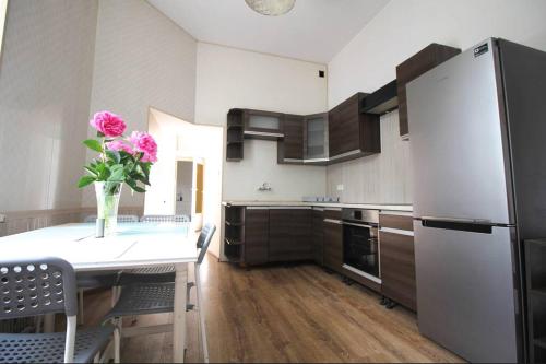 a kitchen with a table with a vase of flowers on it at Simplicity Apartment - Lublin City Center in Lublin