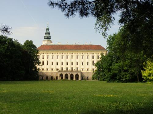 a large building with a tower on top of it at Penzion a Restaurace Na Jízdárně in Kroměříž