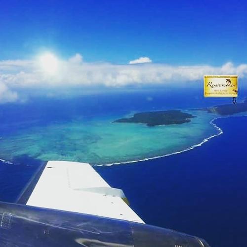 a view of an island in the ocean from an airplane at Hotel ECOLODGE LE RAVORAHA in Sainte Marie
