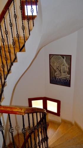 a spiral staircase in a house with a painting on the wall at Eagle Nest in Kaş