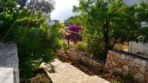 a stone walkway next to a stone wall at Eagle Nest in Kaş