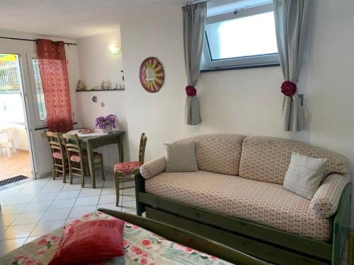a living room with a couch and a table at Appartamenti Tina in Villa Restituta in Ischia