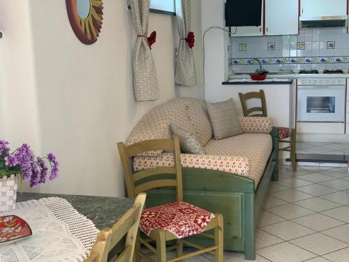 a living room with a couch and a table at Appartamenti Tina in Villa Restituta in Ischia