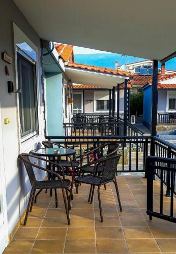 a group of chairs and tables on a balcony at Kerkini Houses in Kerkíni