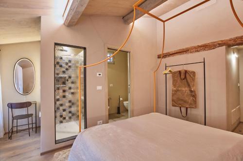 a bedroom with a bed and a glass shower at EL TANO in Città della Pieve