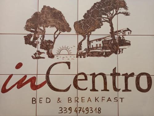 a sign for a bed and breakfast with trees at B&B inCentro in Santa Maria di Castellabate