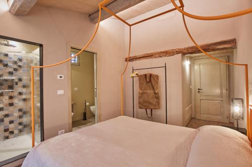 a bedroom with a white bed and a mirror at EL TANO in Città della Pieve