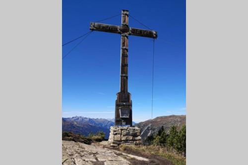 a cross on the top of a mountain at Haus Pachole in Partenen