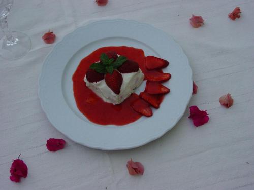 a plate with a strawberry dessert on a table at Dar Paru in Mhamid