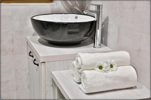 a bathroom with a sink and a towel holder at Zdrojowy Gościniec - domki Rabka-Zdrój in Rabka