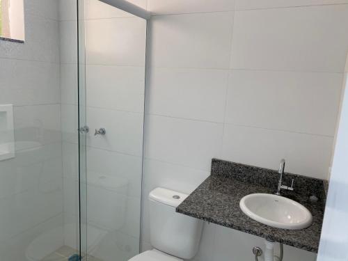 a bathroom with a toilet and a glass shower at Pedra Branca in Campinas