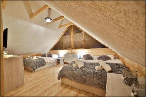 a bedroom with two beds in a attic at Zdrojowy Gościniec - domki Rabka-Zdrój in Rabka