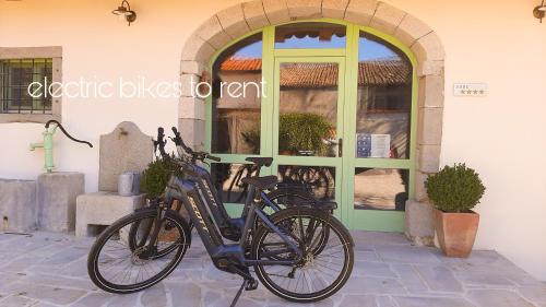two bikes parked in front of a building at Dvor Vipolže in Dobrovo
