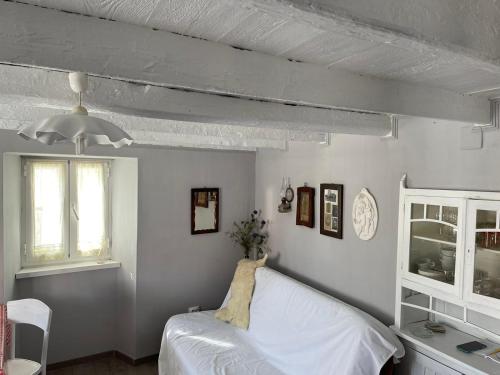 a bedroom with a white bed and a window at Lubenice-Rodinis Room and Apartment in Lubenice