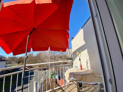 a red umbrella sitting on top of a balcony at Hotel am Rosenbad in Fulda
