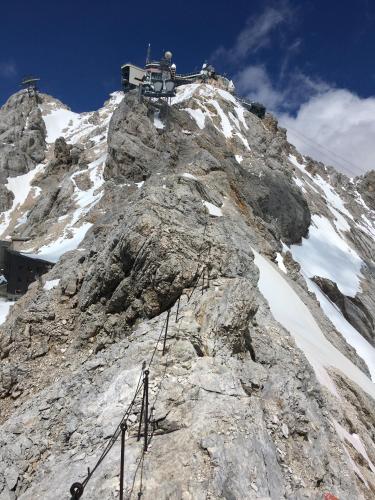 a rocky mountain with a building on top of it at Hotel Alpspitz B&B in Grainau