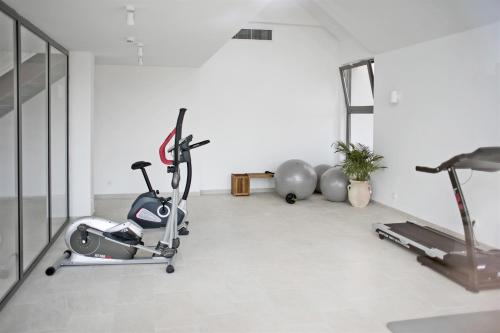 a gym with two exercise bikes and a treadmill at Aminess Vival Port9 Resort in Korčula
