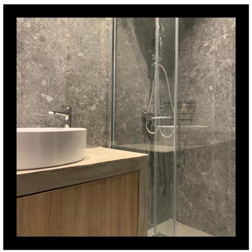 a bathroom with a sink and a shower at Jolene in Thessaloniki