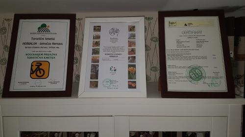 three framed signs sitting on a fireplace mantle at HERBALIJA Apartment Herbalija - sorrounded by Nature in Podčetrtek