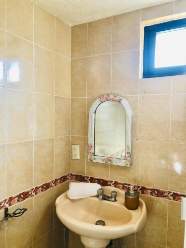 a bathroom with a sink and a mirror at Departamento Rinconcito olivo, 5min centro, home office in Valle de Bravo