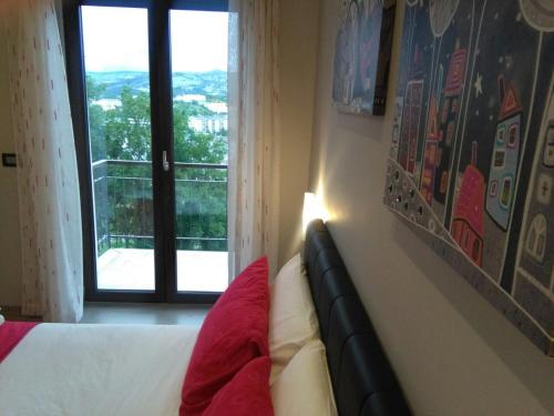 a bedroom with a bed and a window with a view at 85Centro in Potenza