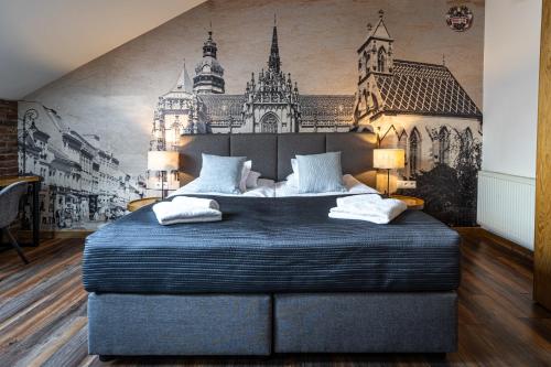 a bedroom with a large bed and a wall mural at Boutique Slovakia Residence in Košice