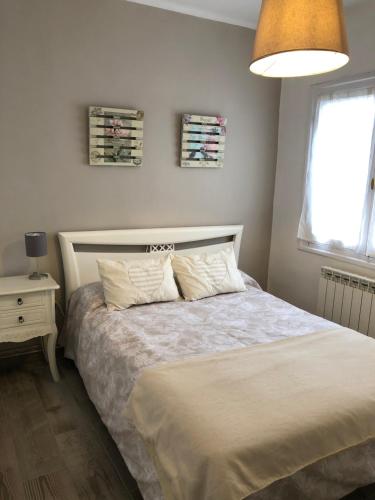 a bedroom with a bed and a lamp and a window at Apartamento Elizondo Giltxaurdi in Elizondo
