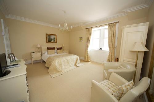a bedroom with a bed and a couch and a chair at Rudha-na-Craige in Inveraray