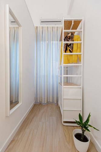 a room with a closet with a plant in it at Les Amis in Syracuse