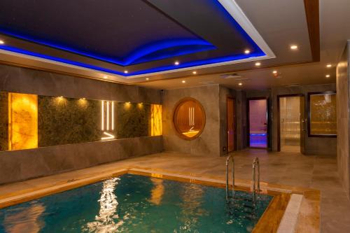a swimming pool in a house with a blue ceiling at Ramada By Wyndham Istanbul Pera Taksim in Istanbul