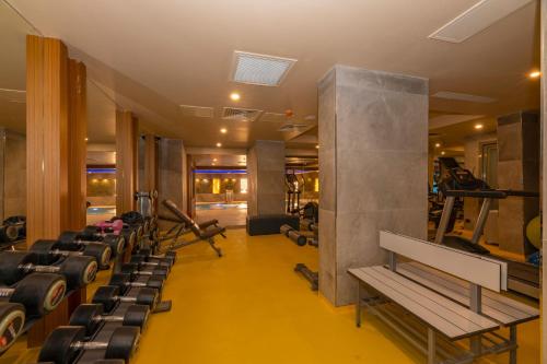 a gym with rows of treadmills and machines at Ramada By Wyndham Istanbul Pera Taksim in Istanbul