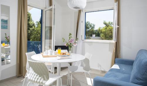 a living room with a table and a blue couch at Aminess Vival Port9 Residence in Korčula