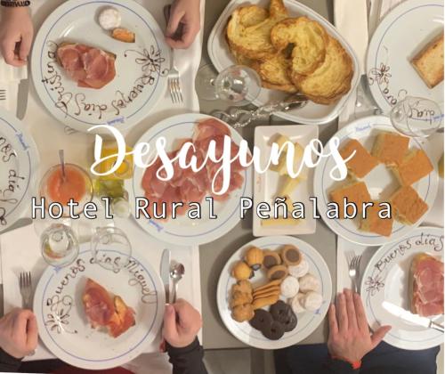 a table full of plates of food with people sitting at it at Hotel Rural Peñalabra in Cervera de Pisuerga