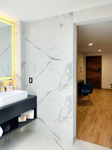 a white bathroom with a sink and a mirror at Ramë Hotel Boutique in Guadalajara