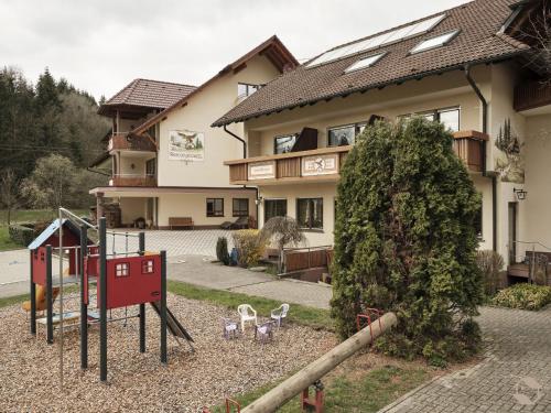 a playground in front of a house at Landgasthof Adler Pelzmühle in Biederbach Baden-Württemberg