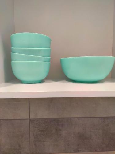 two blue bowls sitting on top of a shelf at Хостел с террасой в центре in Kharkiv