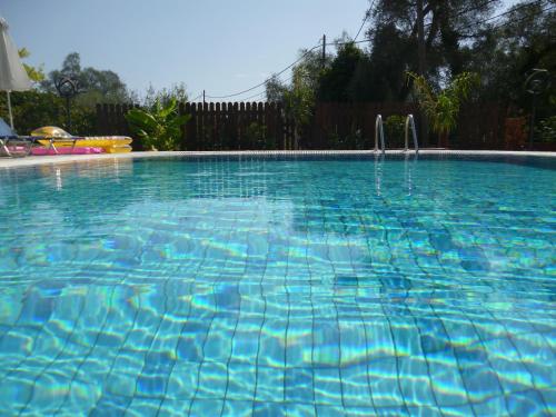 a large swimming pool with blue water at Nature & Blue in Parga