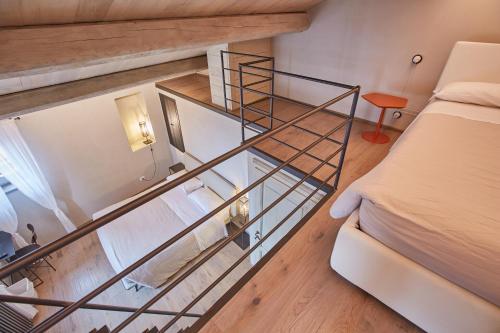 a glass staircase in a room with a bed at EL TANO in Città della Pieve