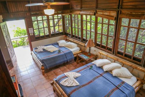 A bed or beds in a room at Aguila de Osa Rainforest Lodge