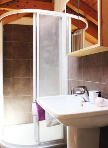 a bathroom with a sink and a shower at "Il Cortile" Apartment in Colico