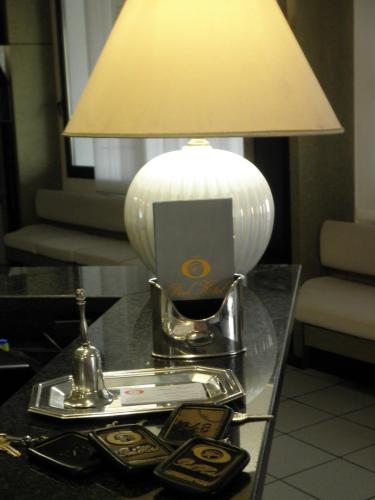 a table with a lamp on top of a table at Park Hotel in Castrocaro Terme