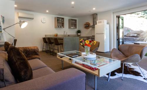 a living room with a couch and a table at Alpine Retreat in Queenstown