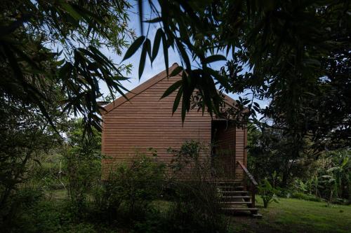 a small wooden building with stairs in a field at Senhora da Rosa, Tradition & Nature Hotel in Ponta Delgada