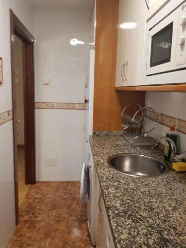 a kitchen with a sink and a counter top at Apartamento La Esperanza in Cangas de Onís