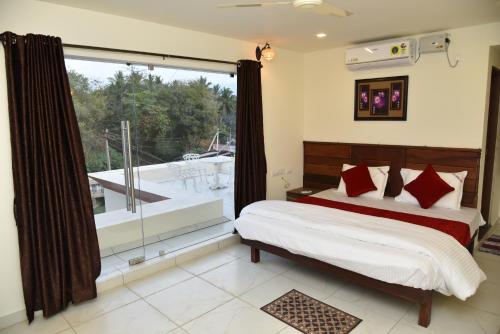 Ένα ή περισσότερα κρεβάτια σε δωμάτιο στο Sree Ganesh Inn