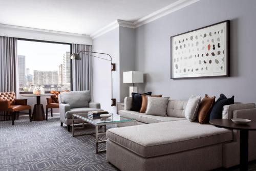 a living room with a couch and chairs and a table at Four Seasons Hotel Atlanta in Atlanta